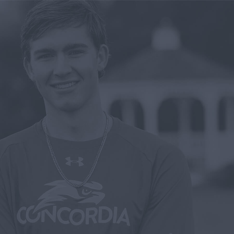 Student athlete pauses next to the gazebo atop the Lake Michigan bluff.