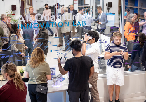 Dedication event at Concordia University Wisconsin's AI Quantum Innovation Lab showing attendees networking and exploring technology demonstrations, including virtual reality.