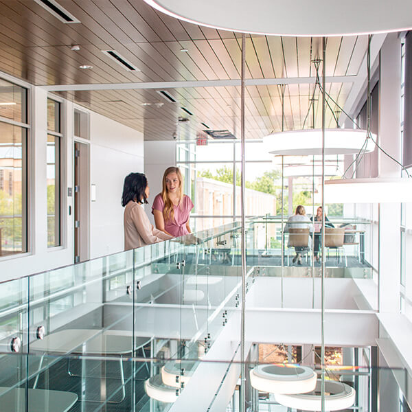 Students talking in the second floor mezzanine of the Robert Plaster building.