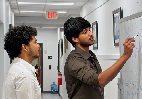 Concordia University Wisconsin's AI & Quantum Innovation Lab featuring glass walls with computer workstations and collaborative seating areas.