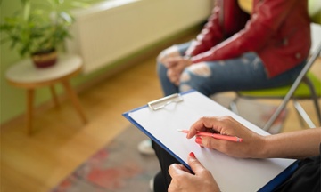 professional counselor in session with a young teen