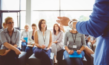 people listening to a speaker