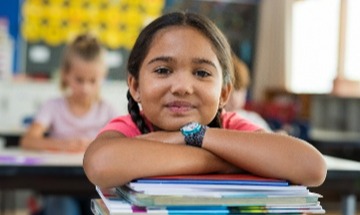 young girl student leaning on books