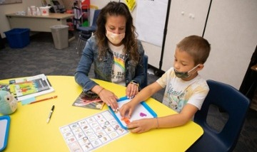 reading teacher working on phonics with elementary student